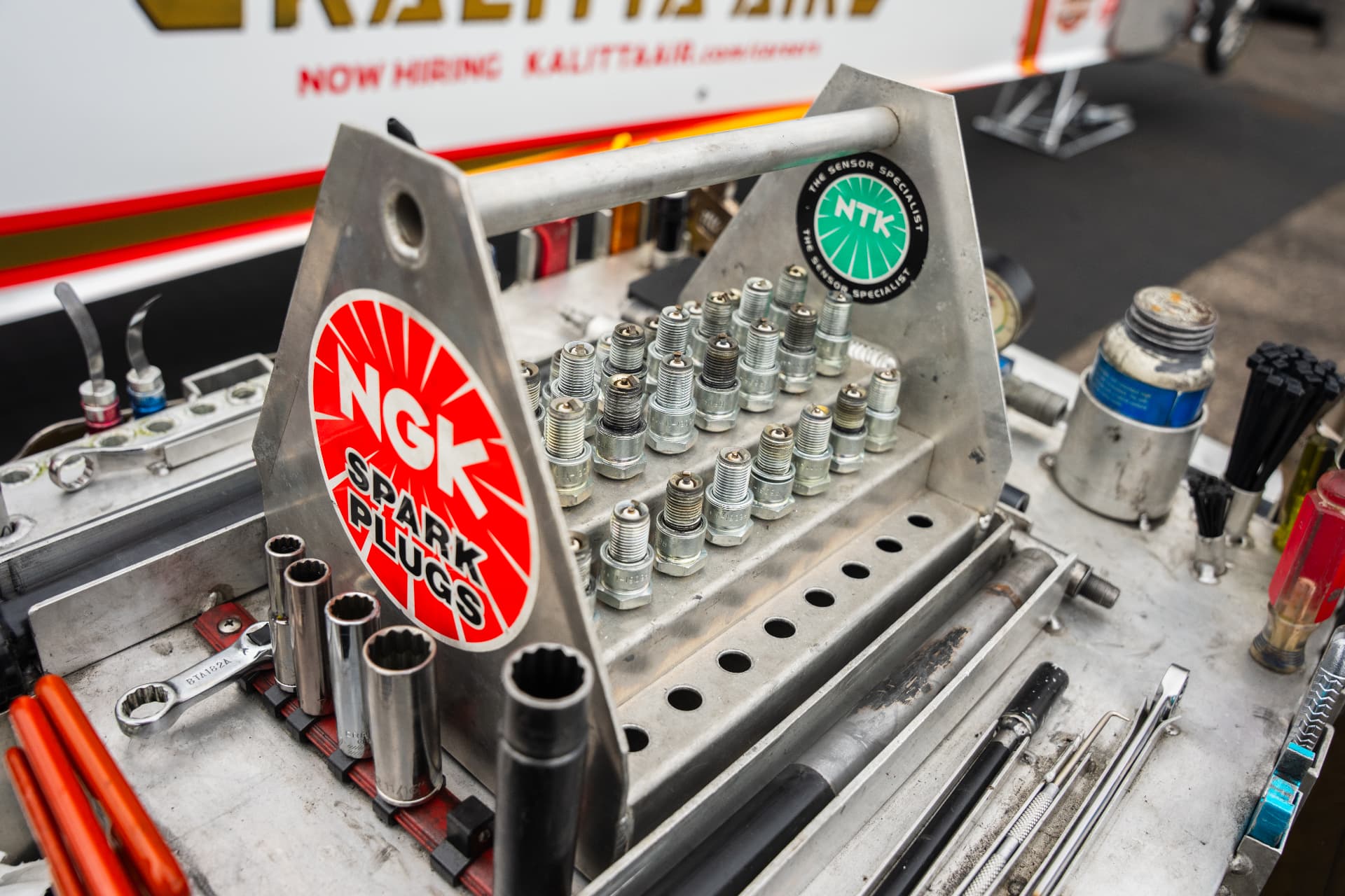 NGK spark plugs laid out on the Randy Meyer Racing work cart
